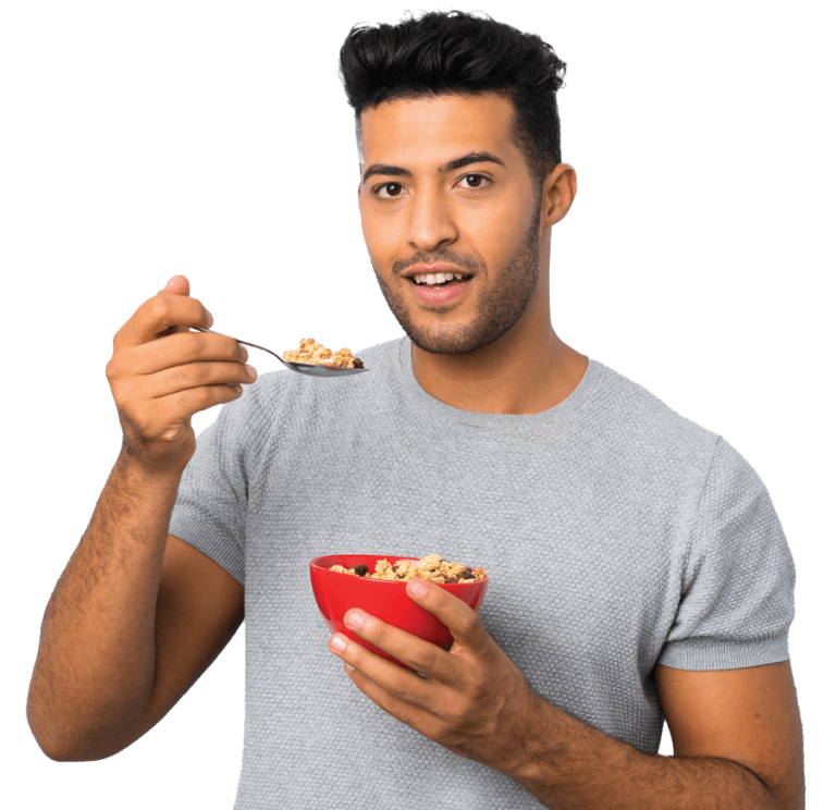 A man with a spoon in hand, relishing a bowl of cereal