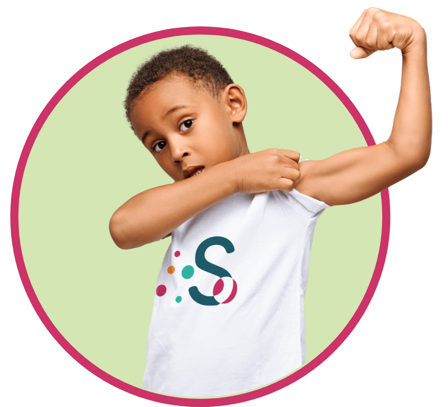 A young boy demonstrates his strength by flexing his arm