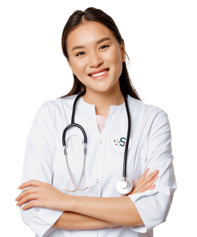 A smiling woman in a white medical coat with a stethoscope draped around her neck stands with arms crossed, representing Vytala clinical nutrition against a plain white background.