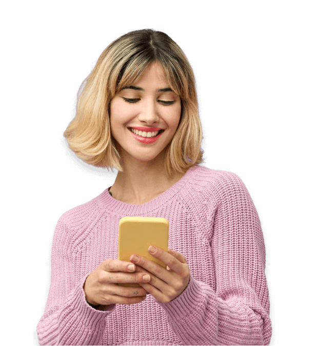 A young woman with short blonde hair and dark roots is smiling while looking at her yellow smartphone. She is wearing a light purple knit sweater against a plain light background, possibly reading about fat malabsorption treatment or Lym-X-Sorb fat absorption technology.